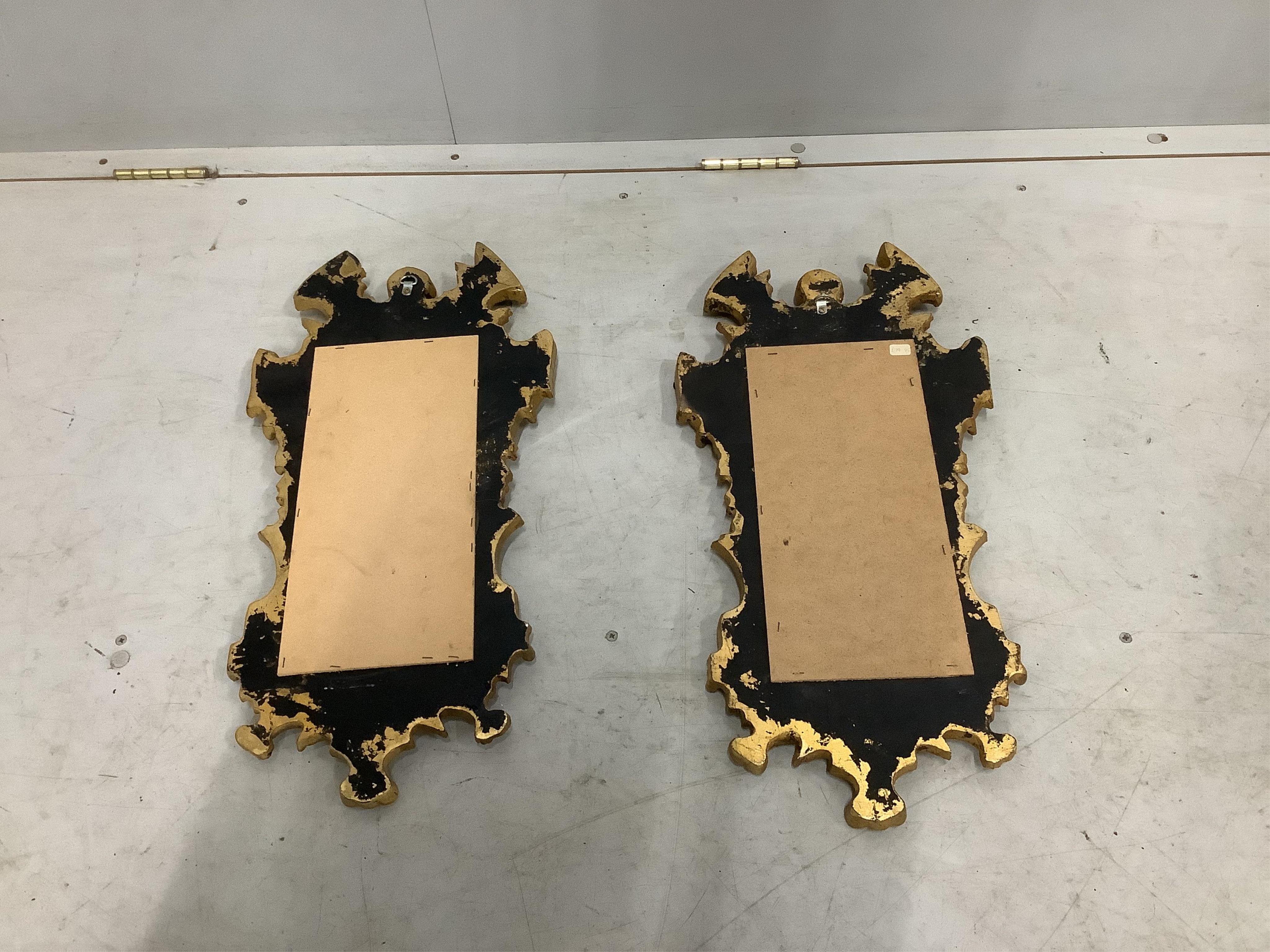 A pair of small reproduction Venetian style gilt composition wall mirrors, width 30cm, height 60cm. Condition - good